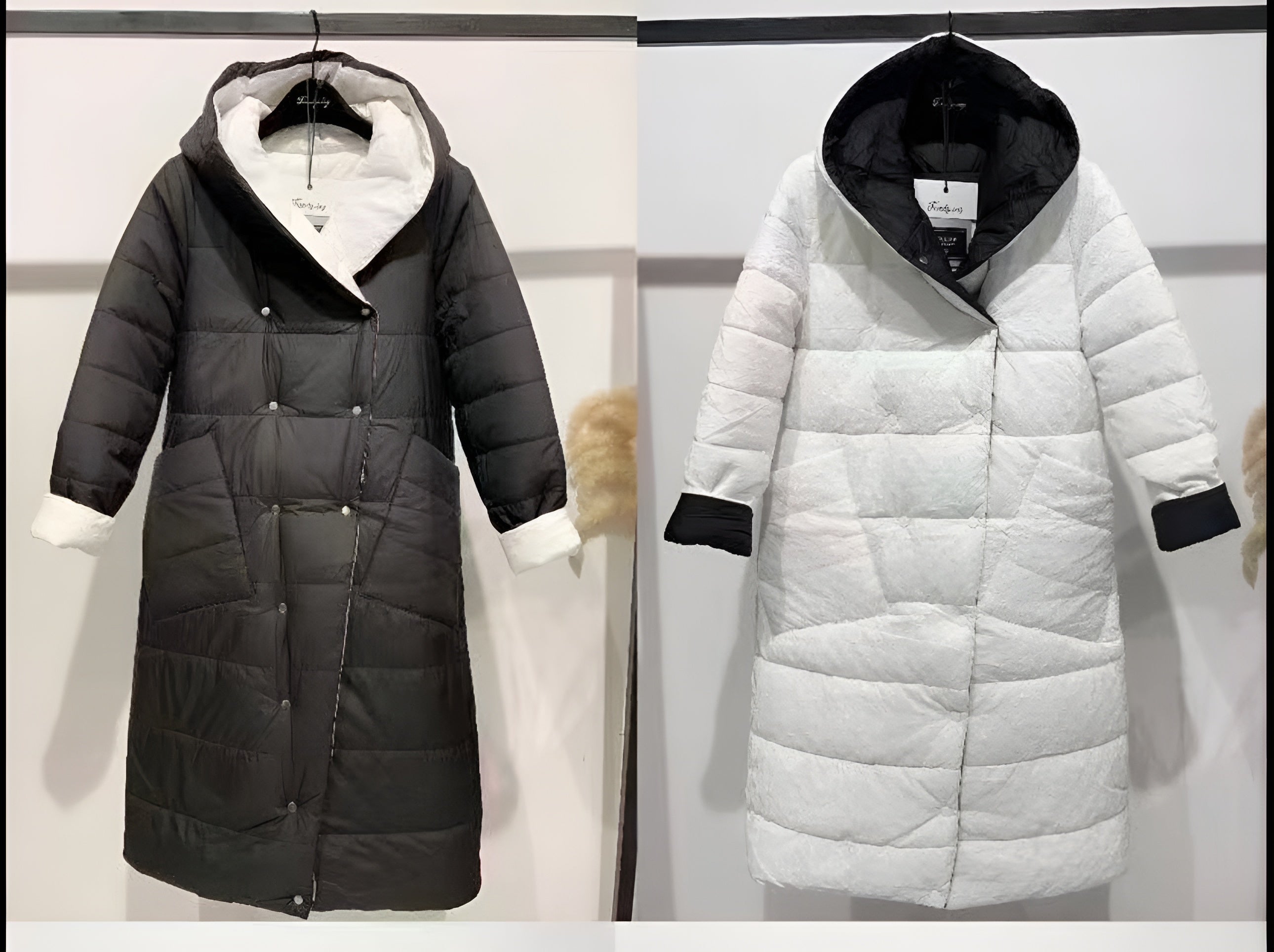 Two long puffer jacket, one black and one white.
